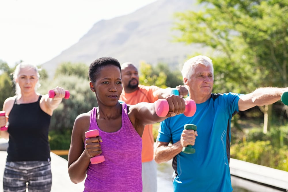 Mature fitness people exercising with dumbbells